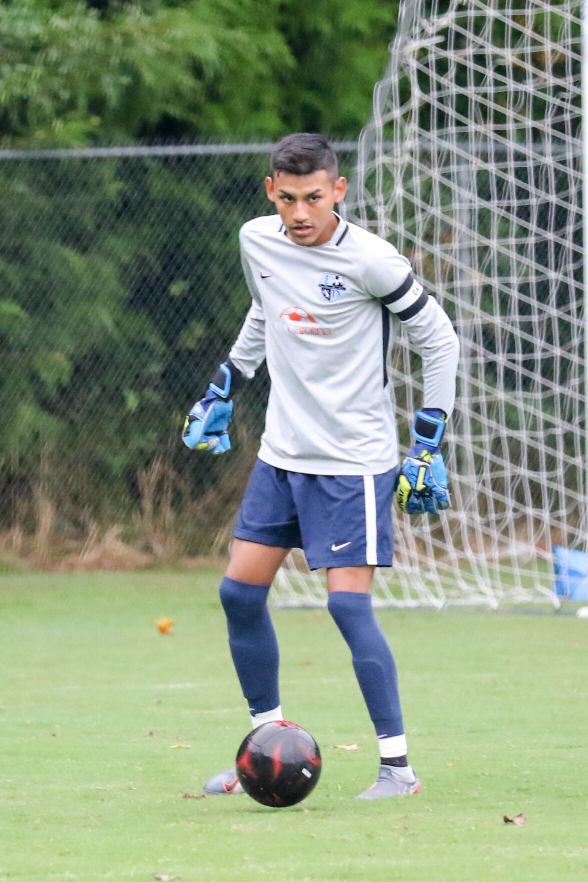 Concord Academy vs Hickory Grove. Ismeal Ortiz, Concord Academy goal keeper keeping his eye on Hickory Grove forward. . Joan Moore/Special to the Independent Tribune